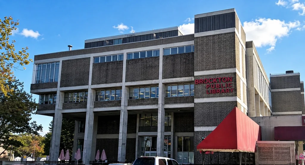 Brutalist library building under clear blue sky.