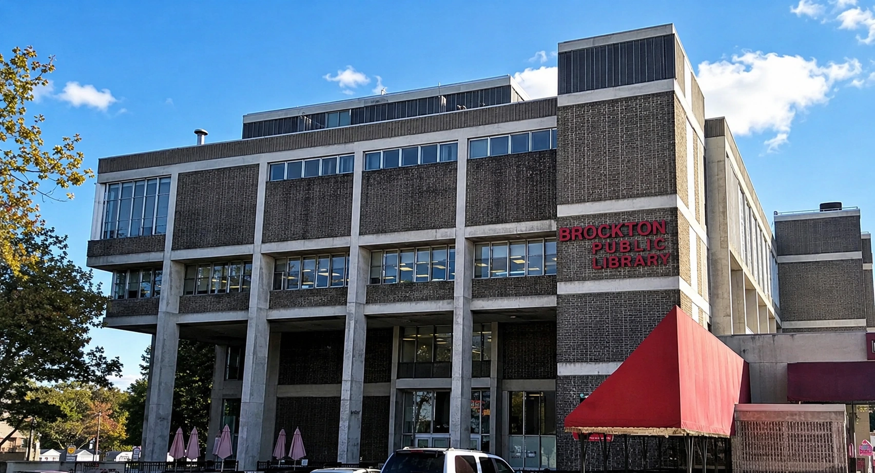 Brutalist library building under clear blue sky.