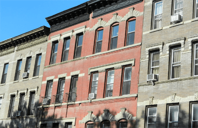 Historic urban apartment buildings under blue sky.