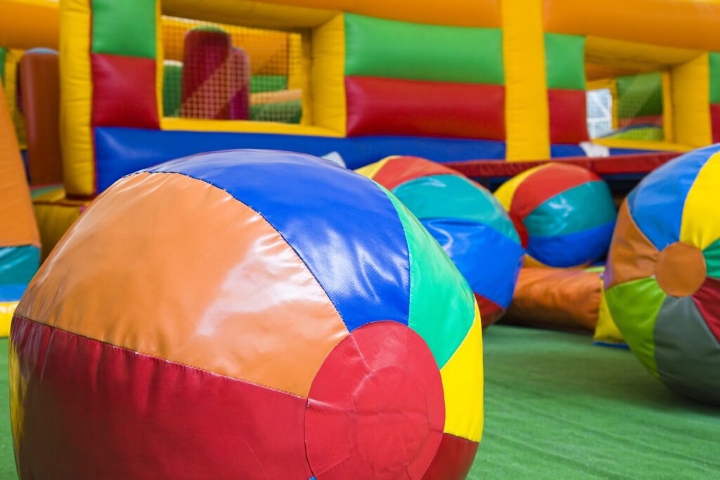 Colorful beach balls in inflatable play area.