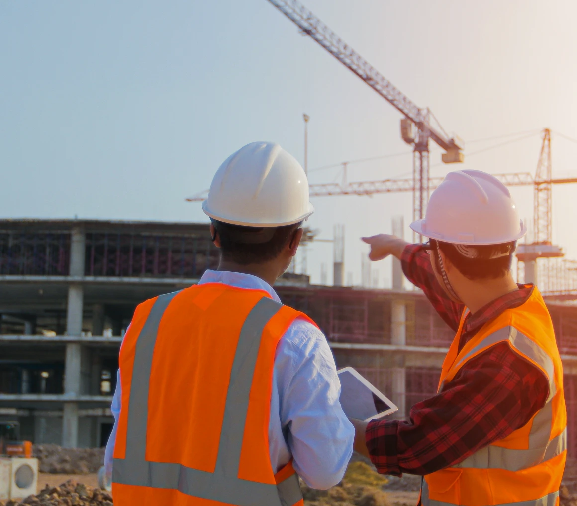 Construction workers assessing building site progress.