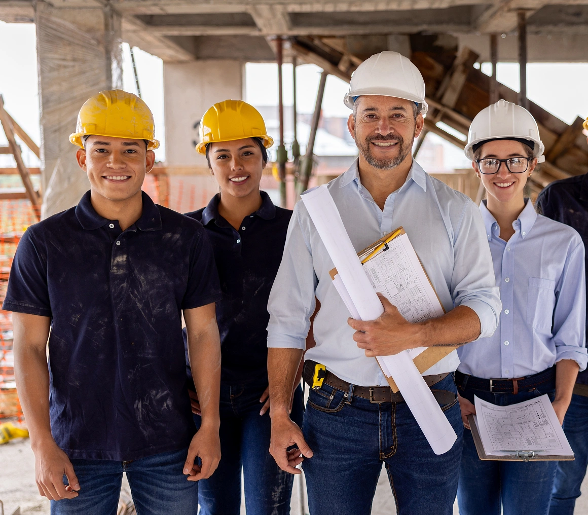 Construction team smiling at building site.