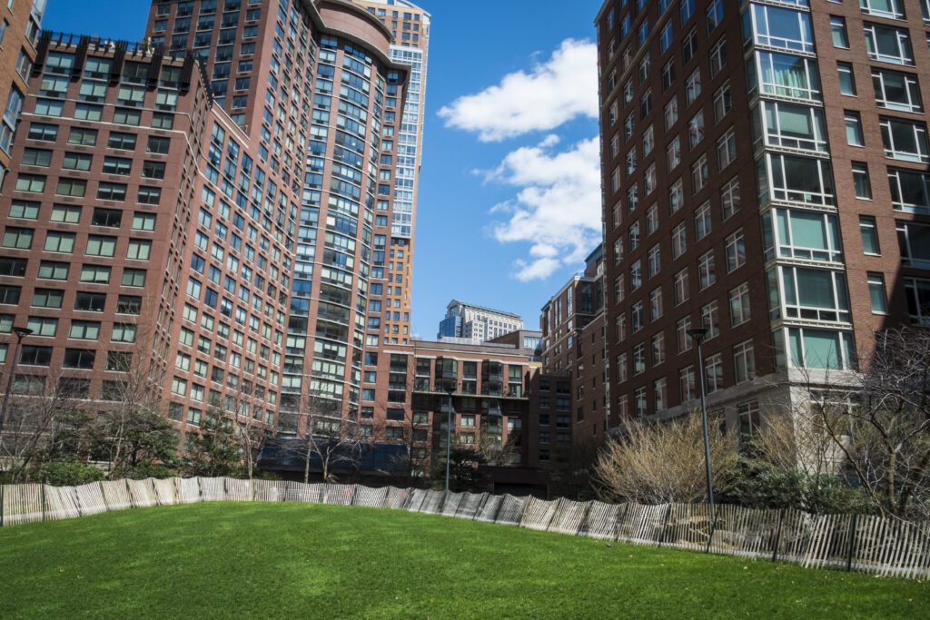 Urban park surrounded by tall buildings.