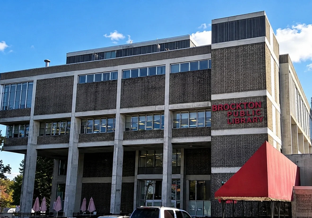 Brutalist library building under clear blue sky.